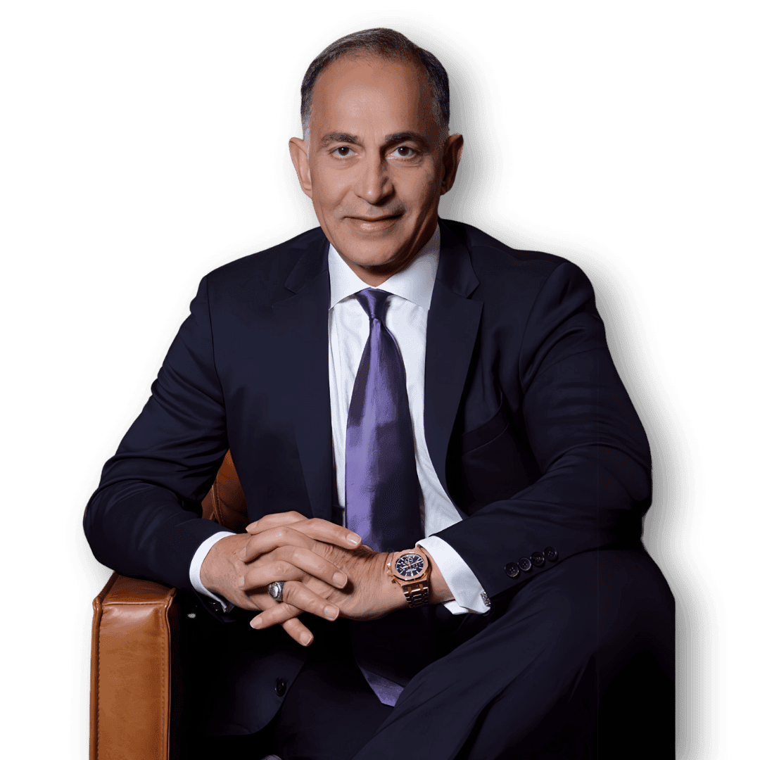 Mo Honarkar seated in a dark suit, hands clasped.